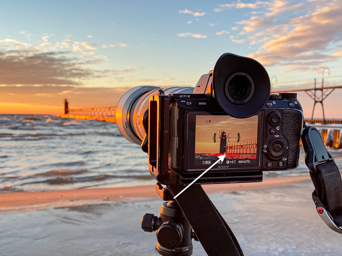 A Sony mirrorless camera set up on a beach for focus peaking