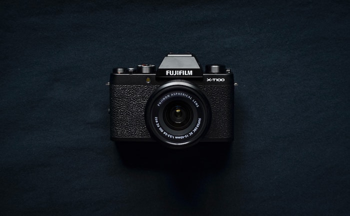 Flatly of compact FujiFilm brand point-and-shoot camera on a black background