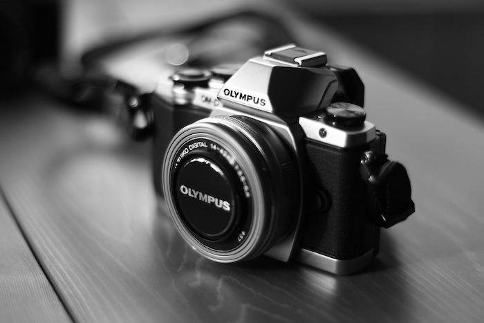 Olympus brand camera and lens on a table