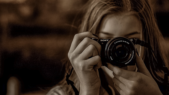 Woman shooting with a Sony compact camera