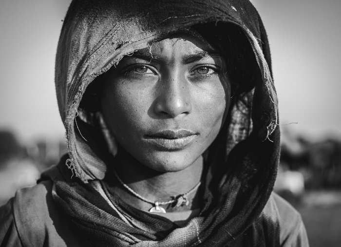 a black and white portrait of a woman wearing a hoodie