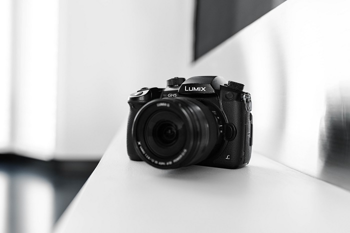 a black and white photo of a Lumix DSLR with shallow depth of field