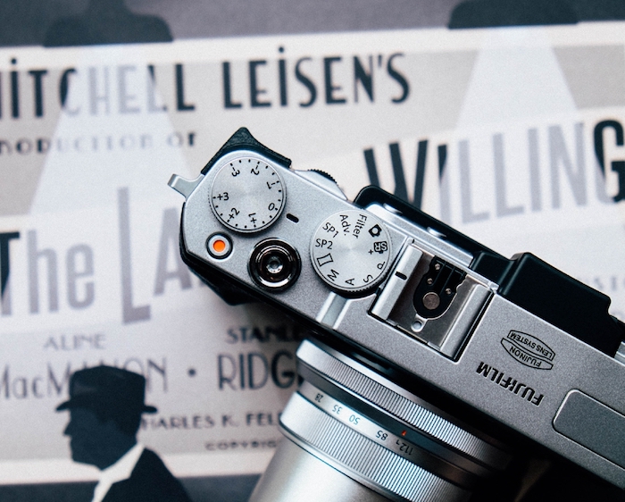 Top view of a Fujifilm camera on top of a playbill