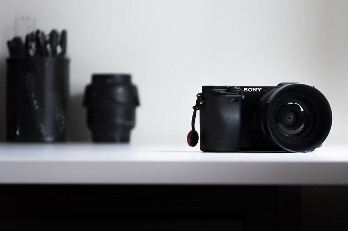Sony a6400 on a white table with lenses behind