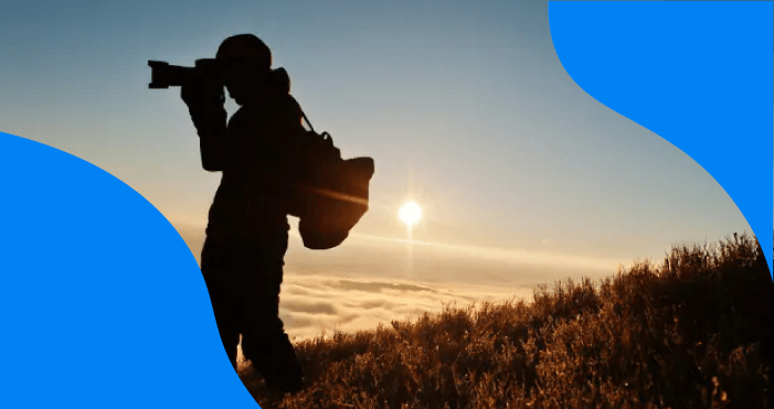 Silhouette of a professional photographer taking photos outdoors