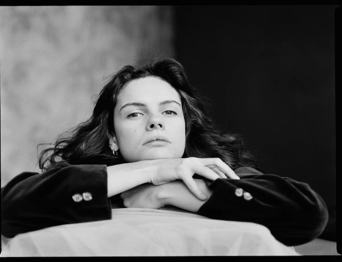 Black and white portrait photo of a girl with crossed arms