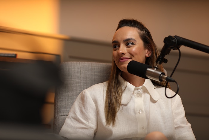 Podcaster siting in a studio using an XLR microphone